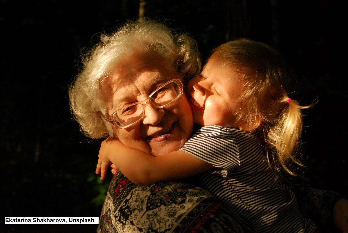 A little girl in a loving embrace with her grandmother